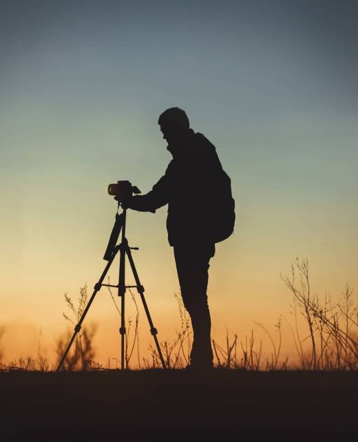 A vertical shot of the silhouette of a man in front of the camera